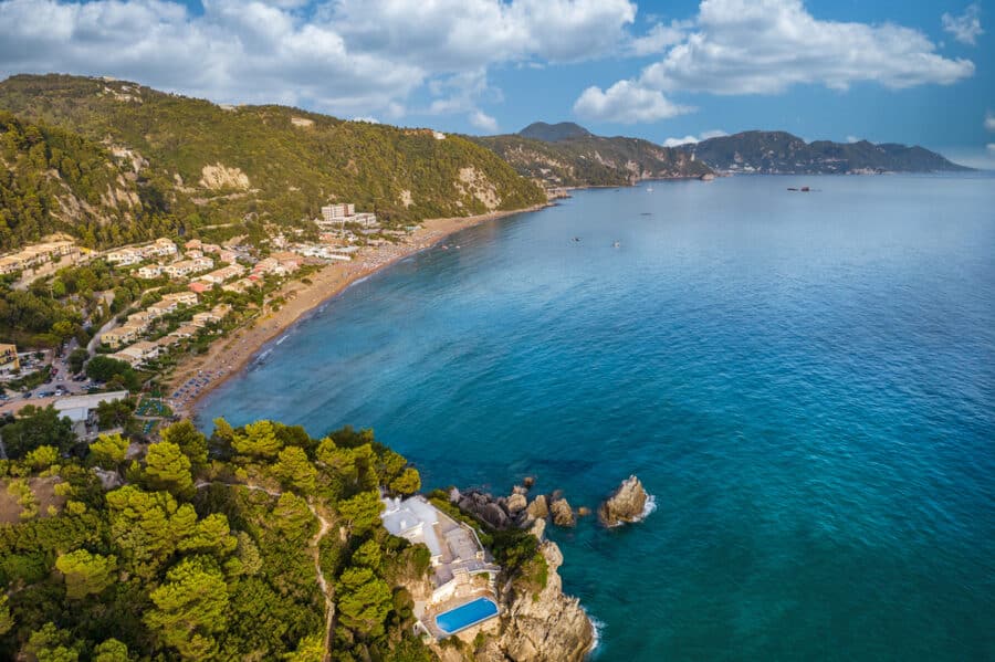 Corfu Beaches - Aerial drone view over western coast and Glyfada beach at sunset