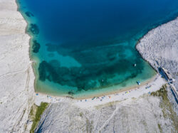 Best Beaches In The Mediterranean -Aerial view of Rucica beach on Pag island, Metajna, Croatia._Depositphotos_205486858_S